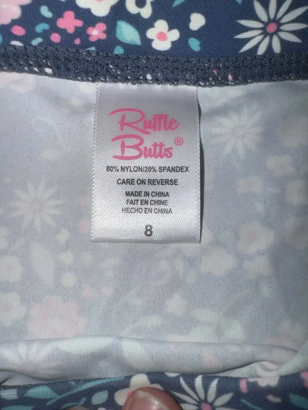 RuffleButts Moonlit Meadow Long Sleeve Peplum Rash Guard Swim Top